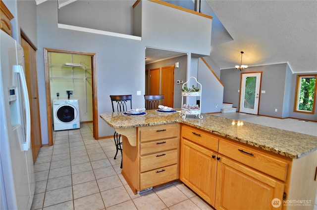 1923 SE Maple Dr, Chehalis, WA 98532 - kitchen featuring white refrigerator with ice dispenser, washer / clothes dryer, light tile patterned flooring, a textured ceiling, and light stone countertops