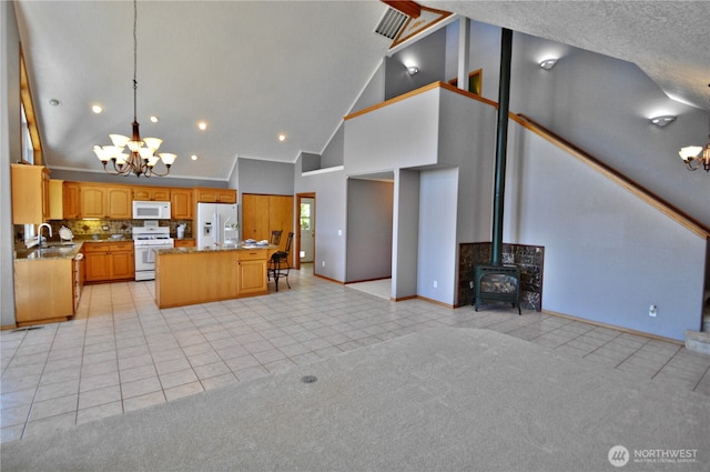 1923 SE Maple Dr, Chehalis, WA 98532 - kitchen with white appliances, a chandelier, high vaulted ceiling, light tile patterned flooring, and open floor plan
