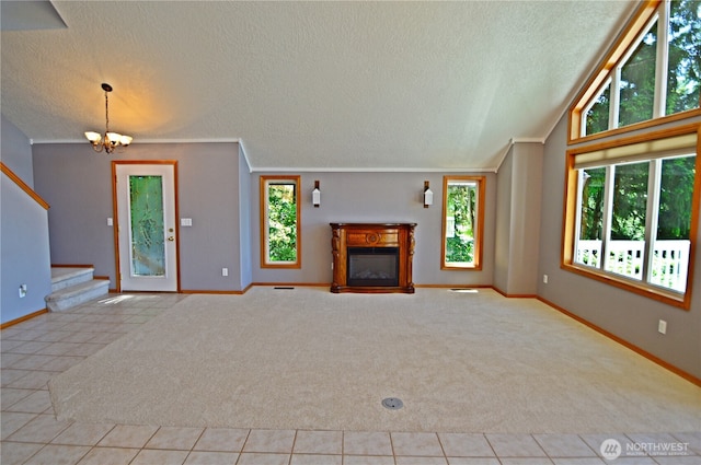 1923 SE Maple Dr, Chehalis, WA 98532 - unfurnished living room with carpet, a textured ceiling, a chandelier, stairs, and a glass covered fireplace