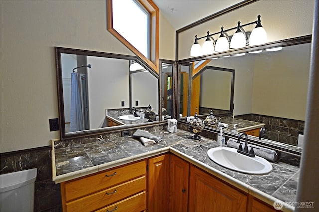1923 SE Maple Dr, Chehalis, WA 98532 - bathroom with double vanity, curtained shower, and a wainscoted wall