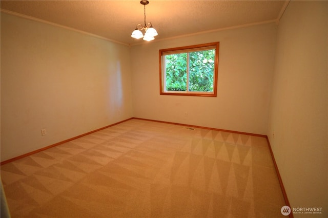 1923 SE Maple Dr, Chehalis, WA 98532 - unfurnished room with light colored carpet, ornamental molding, and a chandelier