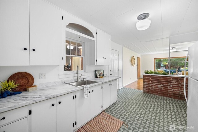 3032 Tulip Rd, Bellingham, WA 98225 - kitchen with light floors, white cabinets, and freestanding refrigerator