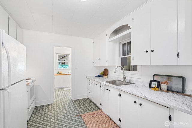 3032 Tulip Rd, Bellingham, WA 98225 - kitchen featuring white appliances, light flooring, white cabinets, and light stone counters