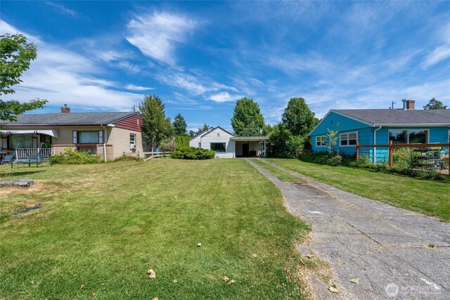 3032 Tulip Rd, Bellingham, WA 98225 - view of green lawn with asphalt driveway and a carport