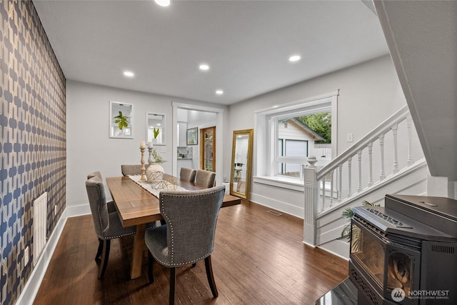8213 S Fawcett Ave, Tacoma, WA 98408 - dining room featuring wallpapered walls, an accent wall, stairs, dark wood-type flooring, and recessed lighting