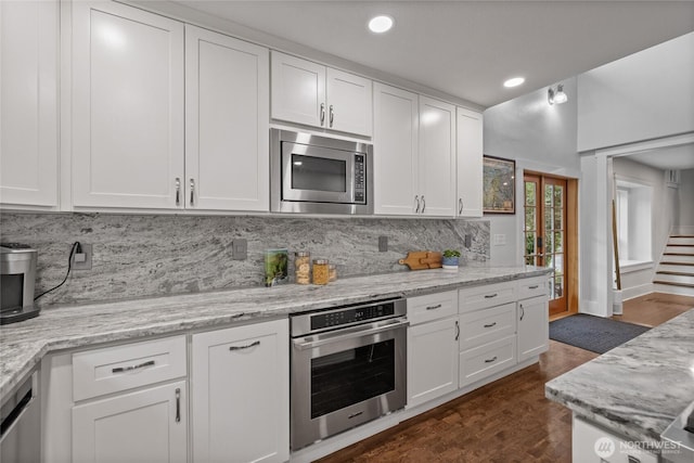 8213 S Fawcett Ave, Tacoma, WA 98408 - kitchen featuring stainless steel appliances, white cabinetry, tasteful backsplash, recessed lighting, and light stone countertops