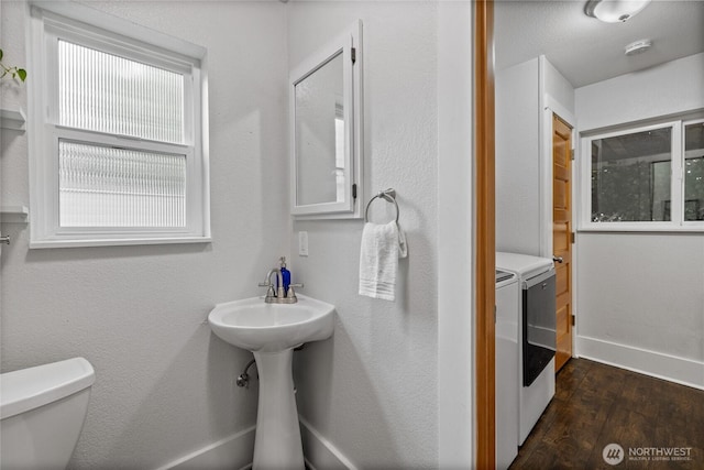 8213 S Fawcett Ave, Tacoma, WA 98408 - bathroom with washing machine and dryer and wood finished floors