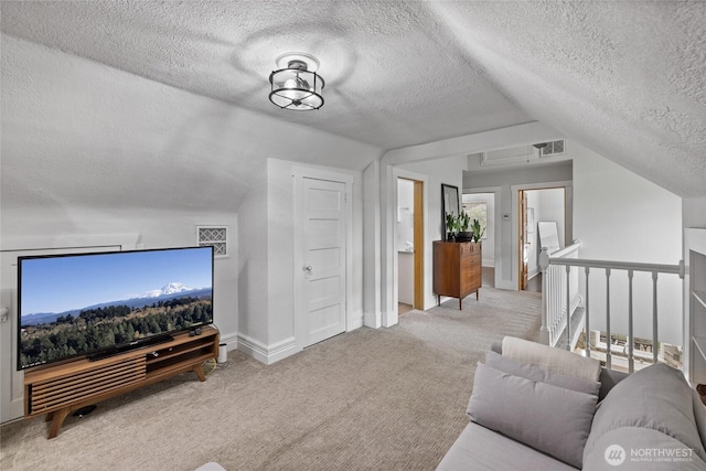 8213 S Fawcett Ave, Tacoma, WA 98408 - carpeted living room with lofted ceiling and a textured ceiling