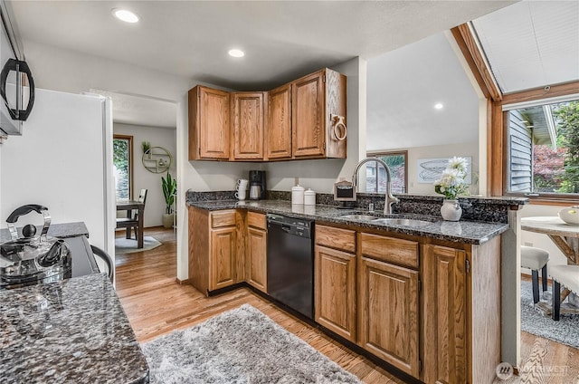 16901 SE 45th St, Bellevue, WA 98006 - kitchen featuring black dishwasher, light wood-style floors, brown cabinetry, dark stone countertops, and recessed lighting
