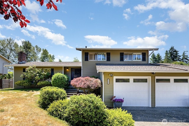 13605 SE 233rd St, Kent, WA 98042 - view of front of property with a garage, driveway, a chimney, and roof with shingles