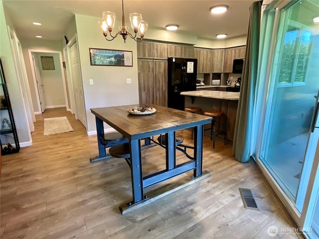 20795 Kahler Dr Unit E7, Leavenworth, WA 98826 - dining space with light wood-style flooring and a chandelier