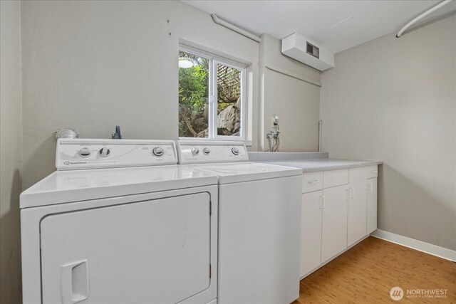 6520 NE 60th St, Seattle, WA 98115 - laundry room with washing machine and clothes dryer, cabinet space, and light wood-type flooring