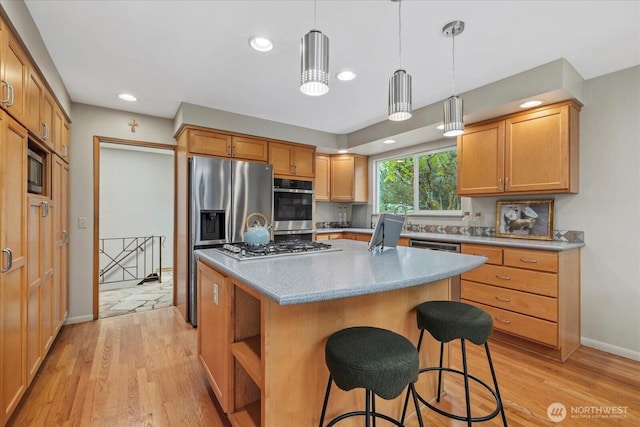 6520 NE 60th St, Seattle, WA 98115 - kitchen featuring stainless steel appliances, light wood-style flooring, a kitchen breakfast bar, a center island, and hanging light fixtures