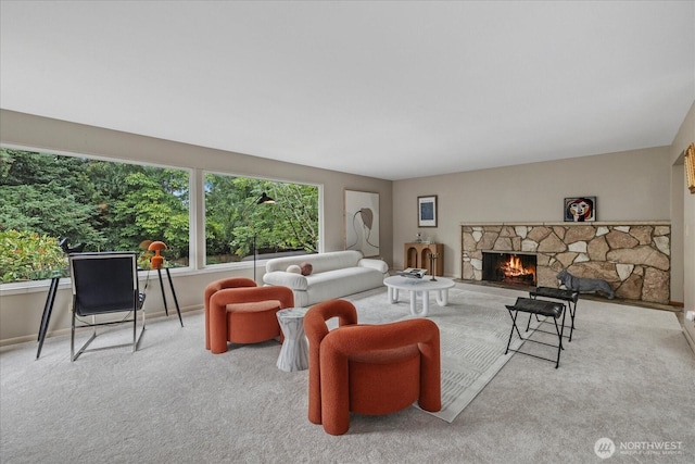 6520 NE 60th St, Seattle, WA 98115 - carpeted living area featuring a stone fireplace and baseboards