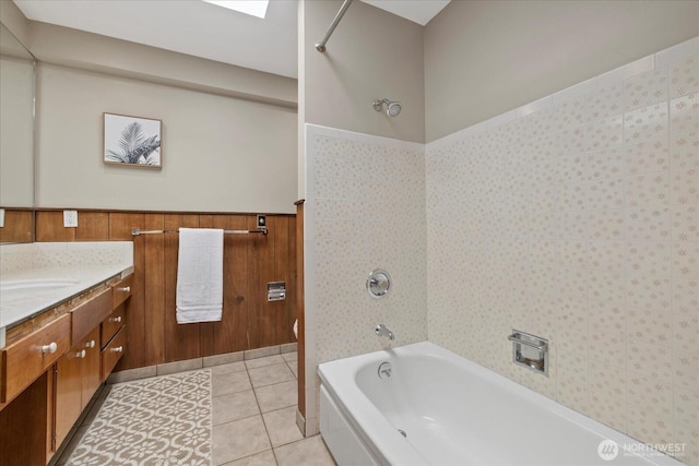 6520 NE 60th St, Seattle, WA 98115 - bathroom featuring vanity, bathing tub / shower combination, a wainscoted wall, and tile patterned floors