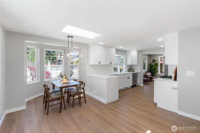 10218 63rd Avenue Ct E, Puyallup, WA 98373 - dining space with a skylight, light wood finished floors, recessed lighting, and a chandelier