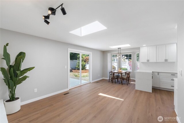 10218 63rd Avenue Ct E, Puyallup, WA 98373 - dining room with a skylight and light wood-style flooring