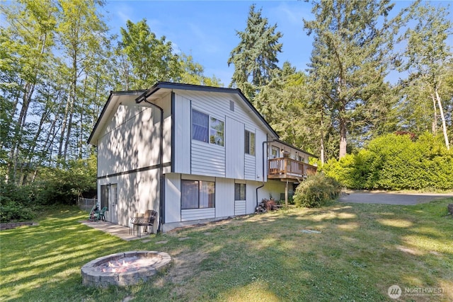 1216 NE Vena Ave, Bremerton, WA 98311 - view of side of home featuring a yard, a fire pit, and a wooden deck