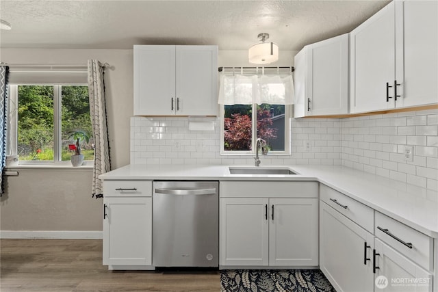 1216 NE Vena Ave, Bremerton, WA 98311 - kitchen featuring stainless steel dishwasher, wood finished floors, white cabinetry, and a textured ceiling