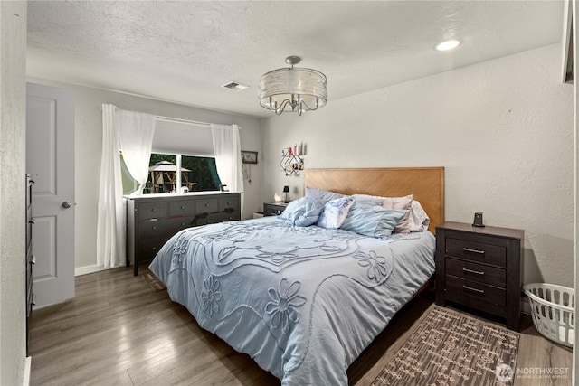 1216 NE Vena Ave, Bremerton, WA 98311 - bedroom with wood finished floors, a chandelier, and a textured ceiling