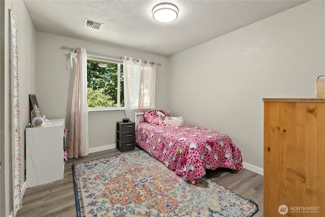 1216 NE Vena Ave, Bremerton, WA 98311 - bedroom with wood finished floors and a textured ceiling