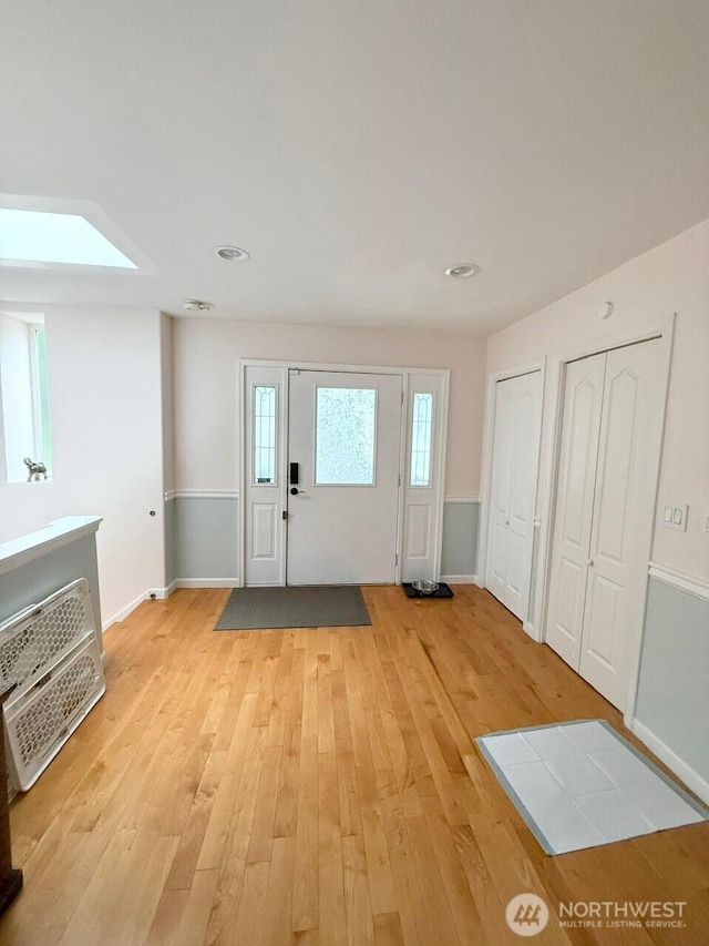 9844 Arrowsmith Ave S, Seattle, WA 98118 - entryway with light wood-style flooring and a skylight