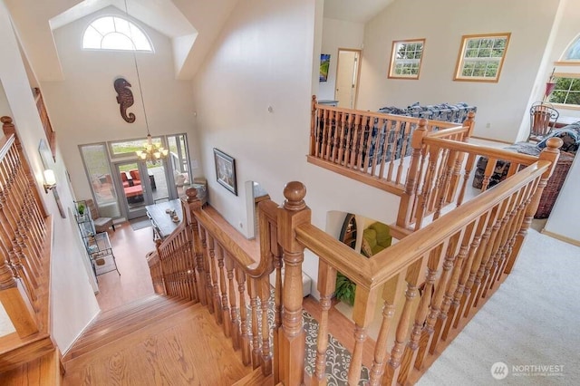 23309 J Pl, Ocean Park, WA 98640 - stairs with a chandelier, high vaulted ceiling, and wood finished floors