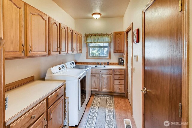 23309 J Pl, Ocean Park, WA 98640 - laundry area with cabinet space, separate washer and dryer, and light wood-type flooring
