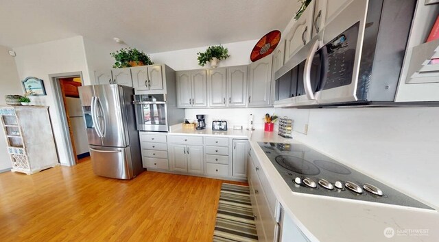 23309 J Pl, Ocean Park, WA 98640 - kitchen featuring stainless steel appliances, light wood-style floors, and light countertops