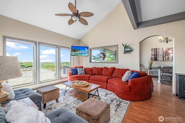 23309 J Pl, Ocean Park, WA 98640 - living area with healthy amount of natural light, wood finished floors, ceiling fan, high vaulted ceiling, and a chandelier