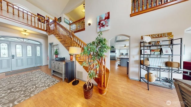 23309 J Pl, Ocean Park, WA 98640 - foyer featuring wood finished floors, stairway, arched walkways, and a high ceiling