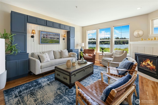 32 Heron Rd, Port Ludlow, WA 98365 - living room with a tile fireplace, plenty of natural light, wood finished floors, recessed lighting, and a water view
