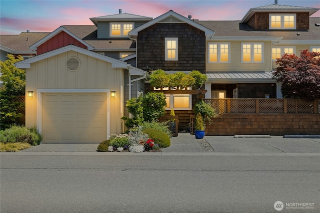 32 Heron Rd, Port Ludlow, WA 98365 - view of front of home with board and batten siding, an attached garage, and concrete driveway