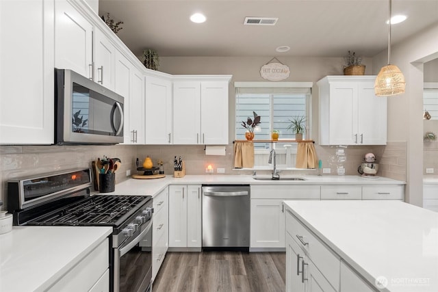 3115 Stephanie Loop NE, Lacey, WA 98516 - kitchen featuring stainless steel appliances, white cabinetry, backsplash, light countertops, and recessed lighting