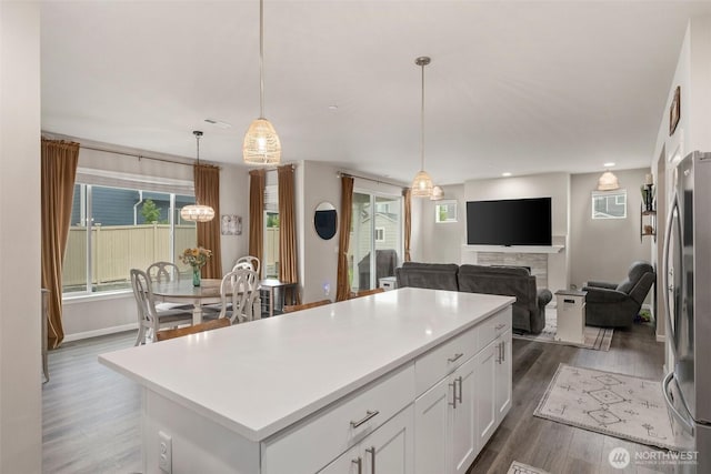 3115 Stephanie Loop NE, Lacey, WA 98516 - kitchen featuring freestanding refrigerator, dark wood finished floors, white cabinetry, a kitchen island, and light countertops