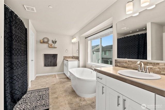 3115 Stephanie Loop NE, Lacey, WA 98516 - full bathroom with two vanities, a soaking tub, a shower with shower curtain, and tasteful backsplash