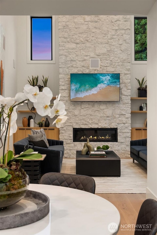 10425 NE 28th Pl, Bellevue, WA 98004 - living area with a stone fireplace and wood finished floors