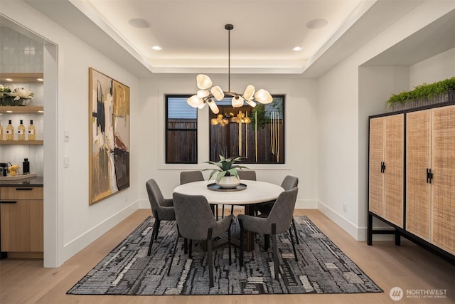 10425 NE 28th Pl, Bellevue, WA 98004 - dining room featuring light wood-type flooring, a chandelier, and a tray ceiling
