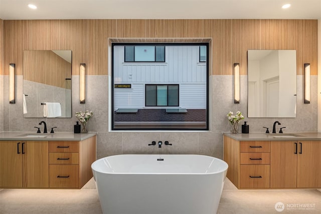 10425 NE 28th Pl, Bellevue, WA 98004 - bathroom with two vanities, a soaking tub, and tile walls