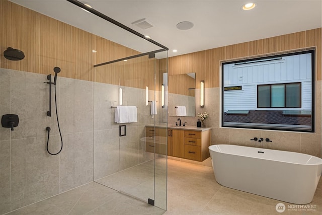 10425 NE 28th Pl, Bellevue, WA 98004 - full bathroom with a shower stall, vanity, a soaking tub, tile patterned flooring, and tile walls