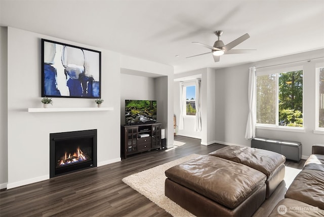 27156 NE Walden Way, Duvall, WA 98019 - living area with dark wood-type flooring, a ceiling fan, and a warm lit fireplace