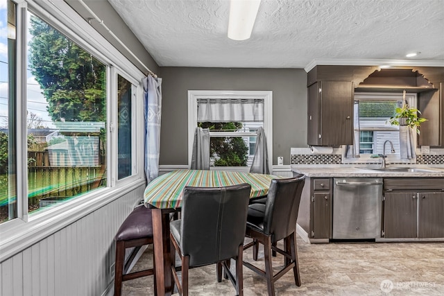 516 26th Ave, Longview, WA 98632 - kitchen with dishwasher, dark brown cabinets, light countertops, plenty of natural light, and a textured ceiling