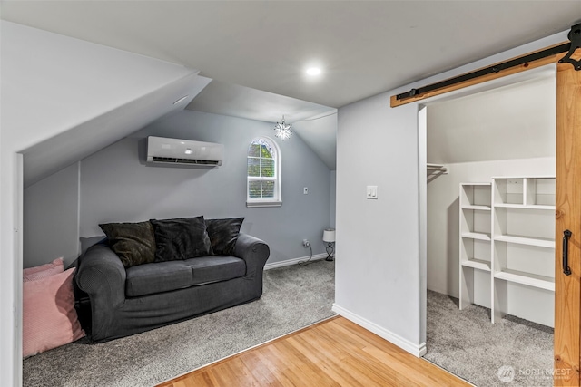 516 26th Ave, Longview, WA 98632 - living room with a barn door, a wall mounted AC, wood finished floors, and lofted ceiling