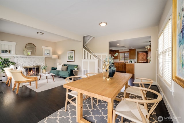 4745 35th Ave SW, Seattle, WA 98126 - dining space with dark wood-type flooring, stairway, a fireplace, and recessed lighting
