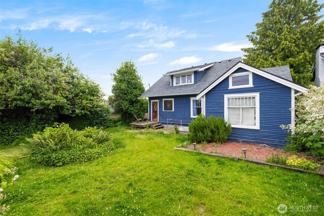 4745 35th Ave SW, Seattle, WA 98126 - rear view of house with a yard and a shingled roof