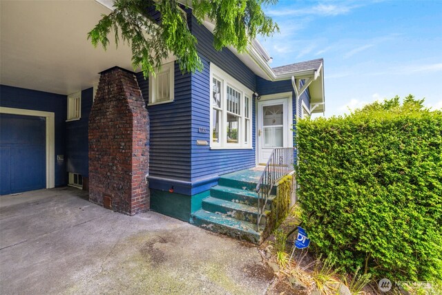 4745 35th Ave SW, Seattle, WA 98126 - view of property exterior featuring a garage and concrete driveway