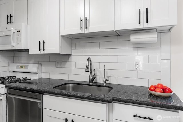 5029 84th St SW Unit 109, Mukilteo, WA 98275 - kitchen featuring white microwave, range, stainless steel dishwasher, white cabinetry, and backsplash