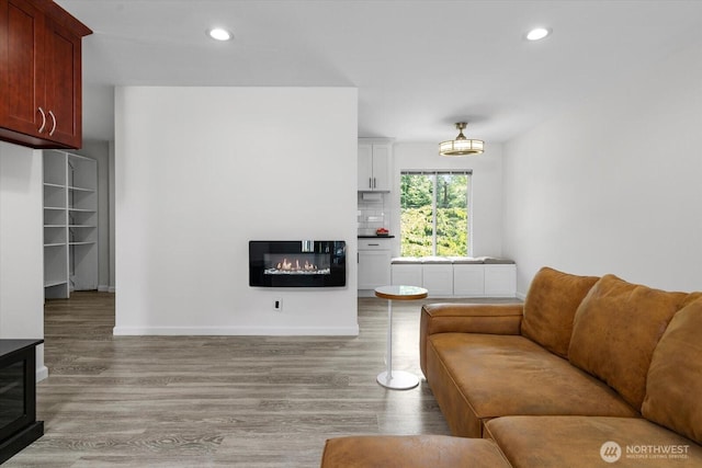 5029 84th St SW Unit 109, Mukilteo, WA 98275 - living area with a glass covered fireplace, light wood-type flooring, and recessed lighting