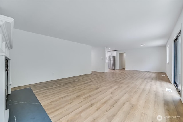 13428 SE 302nd Pl, Auburn, WA 98092 - unfurnished living room with light wood-style floors
