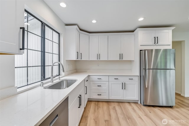 13428 SE 302nd Pl, Auburn, WA 98092 - kitchen with freestanding refrigerator, white cabinetry, light wood-style floors, light stone counters, and recessed lighting